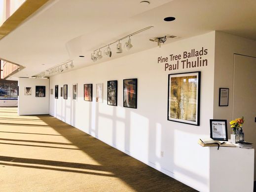Pine Tree Ballads exhibition, a long gallery wall with title text